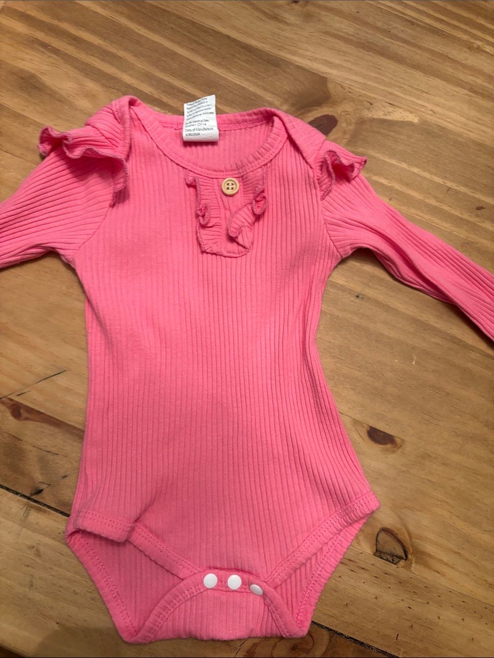 Ribbed Pink Long-Sleeve Baby Bodysuit with Ruffle Detail